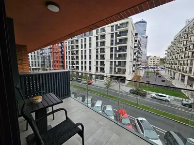 a balcony with a table and a view of a city at BwMils Apartment in Belgrade