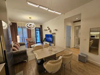 a living room with a table and chairs at BwMils Apartment in Belgrade