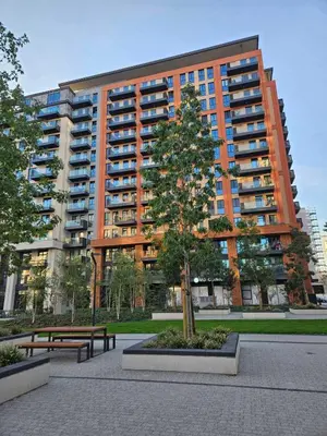 a large apartment building with a tree in front of it at BwMils Apartment in Belgrade
