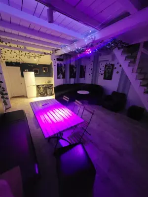a purple room with a table and some chairs at Pool House 365 in Pe°ani