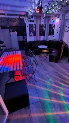 a room with a dance floor with colorful lights at Pool House 365 in Pe°ani