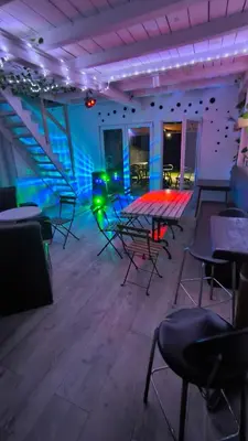 a room with tables and chairs and lights at Pool House 365 in Pe°ani