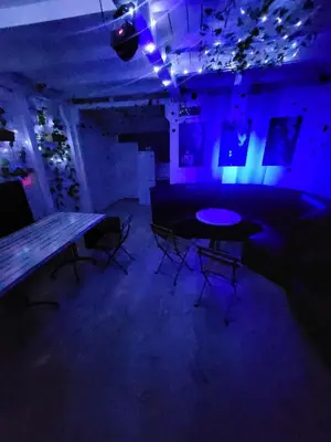 a blue room with a table and chairs in it at Pool House 365 in Pe°ani