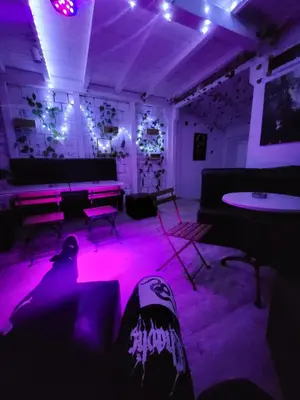a room with purple lights and a person laying on the floor at Pool House 365 in Pe°ani