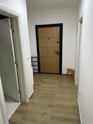 a hallway with a door and a wooden floor at MM Apartman in Stara Pazova