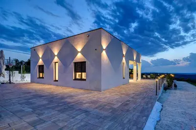 a building with lights on the side of it at Hill Luxury House in Šepšin