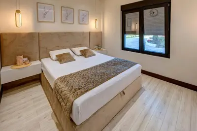 a bedroom with a large bed and a window at Hill Luxury House in Šepšin