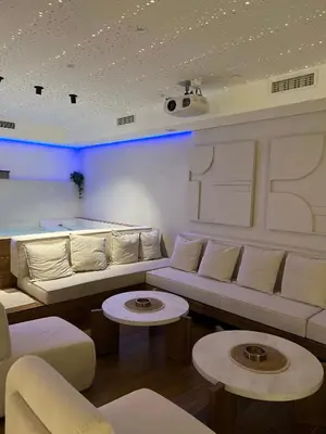 a living room with a couch and two tables at Hill Luxury House in Šepšin