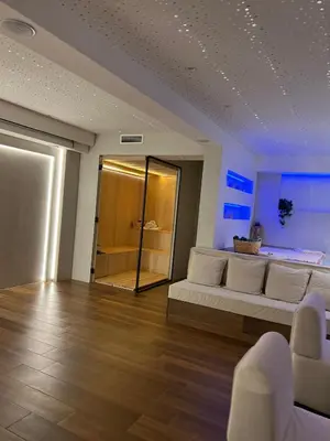 a living room with a white couch and a mirror at Hill Luxury House in Šepšin