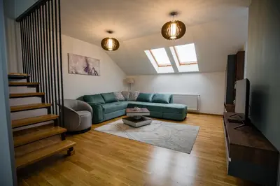 a living room with a green couch and a tv at TOP VIEW apartment 43 in Arandjelovac