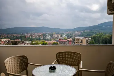 a table and chairs on a balcony with a view at TOP VIEW apartment 43 in Arandjelovac