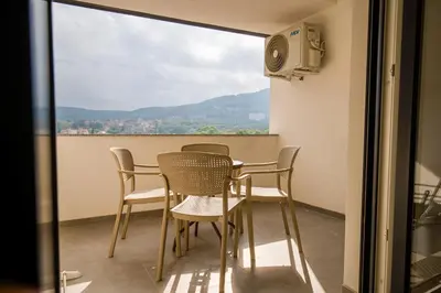 a table and chairs on a balcony with a view at TOP VIEW apartment 43 in Arandjelovac