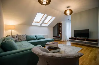 a living room with a green couch and a tv at TOP VIEW apartment 43 in Arandjelovac