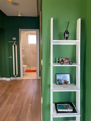 a room with green walls and a white shelf at Hram Vracar in Belgrade