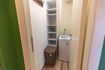 a small bathroom with a refrigerator and a shelf at Hram Vracar in Belgrade