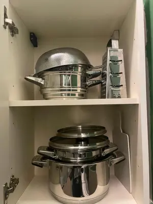 two pots and pans sitting on shelves in a refrigerator at Hram Vracar in Belgrade