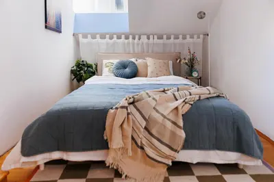 a bedroom with a large bed with a blanket on it at Urban Corner 5min to Republic Square Renovated in Belgrade