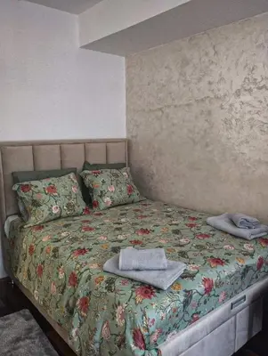 a bedroom with a bed with towels on it at Studio-Harmony in Kanarevo Brdo