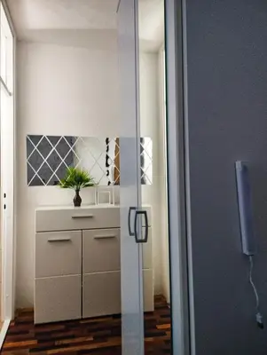 a room with a cabinet and a plant in it at Studio-Harmony in Kanarevo Brdo