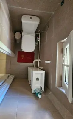 a small bathroom with a toilet and a sink at Potkrovlje Riki u centru Beograda in Belgrade