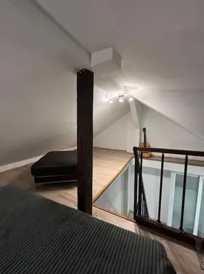 a room with a bed and a glass staircase at Potkrovlje Riki u centru Beograda in Belgrade