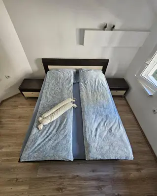 a bed with a tie and baseball equipment on it at Potkrovlje Riki u centru Beograda in Belgrade