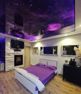 a bedroom with a bed and a purple ceiling at Stone Spa Apartman 2 in Sremčica