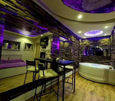 a bathroom with a table and a bath tub at Stone Spa Apartman 2 in Sremčica
