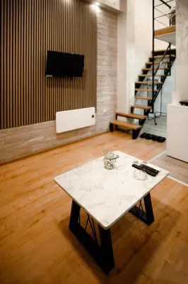 a coffee table in a room with a tv at CROWNE Stan11550 Sopstveno Parking Mesto in Lazarevac