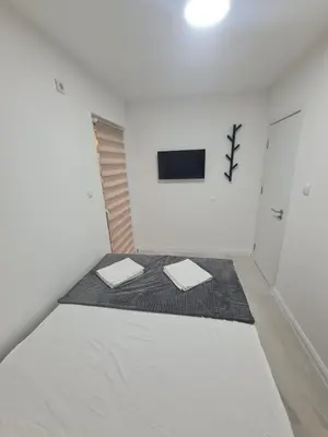 a white room with two mats on the floor at Marash apartman 2 in Belgrade
