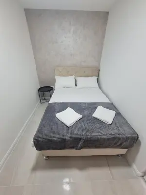 a bedroom with a bed with two white towels on it at Marash apartman 2 in Belgrade