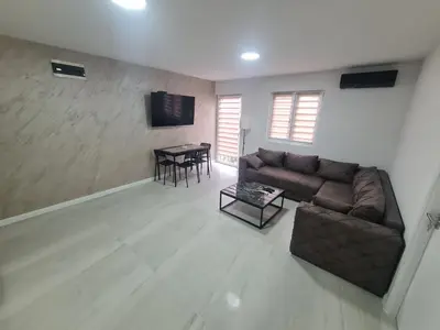 a living room with a couch and a table at Marash apartman 2 in Belgrade