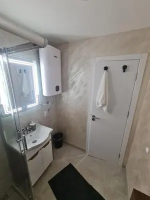 a small bathroom with a shower and a sink at Marash apartman 2 in Belgrade