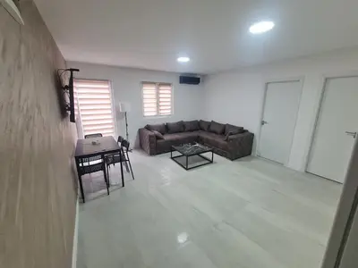 a living room with a couch and a table at Marash apartman 2 in Belgrade