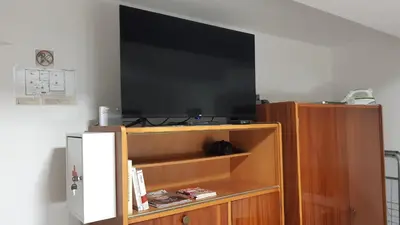 a flat screen tv sitting on top of a cabinet at Apartman Toki, Aranđelovac in Arandjelovac