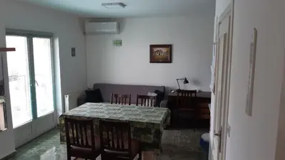 a dining room with a table and chairs and a table and a dining room at Apartman Toki, Aranđelovac in Arandjelovac