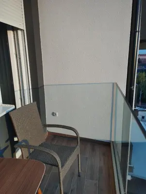 a chair and a table in a room with a window at Amare in Inđija
