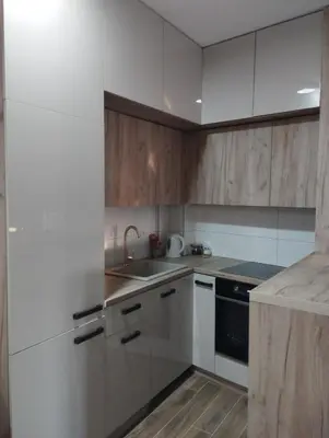 a kitchen with white cabinets and a sink at Amare in Inđija