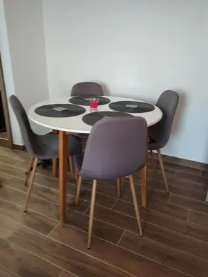 a table with four chairs and a white table at Amare in Inđija