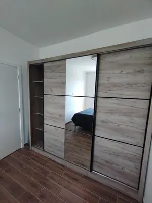 a large sliding door with a mirror in a room at Amare in Inđija