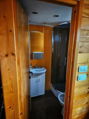 a bathroom with a toilet and a sink and a shower at Splav na Savi in Ostružnica