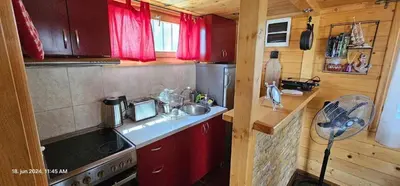 a small kitchen with a sink and a stove at Splav na Savi in Ostružnica