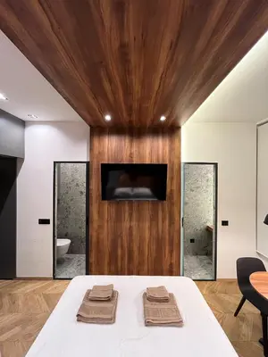 a bedroom with a bed with two towels on it at Riverside Heritage Lux and Modern in Sajmište