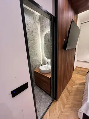 a bathroom with a sink and a mirror at Riverside Heritage Lux and Modern in Sajmište