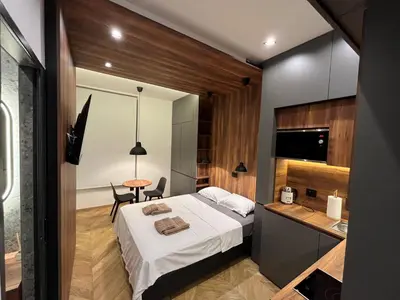 a bedroom with a bed and a desk and a table at Riverside Heritage Lux and Modern in Sajmište