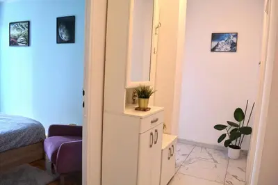 a bedroom with a mirror on a cabinet and a bed at Dorcol Downtown Sunset in Belgrade