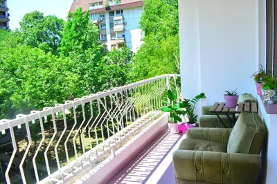 a balcony with a couch sitting on a balcony at Dorcol Downtown Sunset in Belgrade