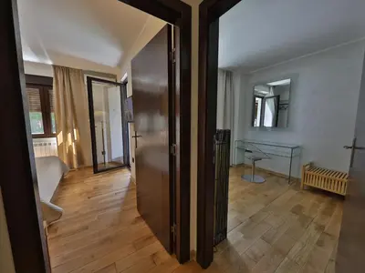 a hallway with a door leading to a living room at Palace Apartment City Center in Belgrade