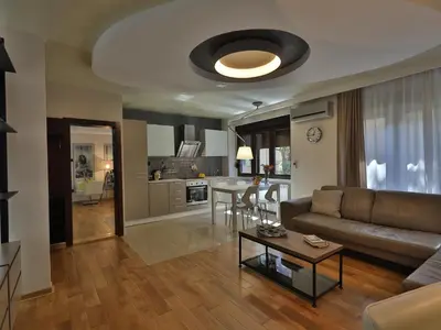 a living room with a couch and a table at Palace Apartment City Center in Belgrade