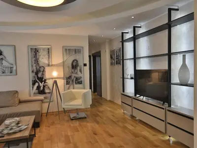 a living room with a couch and a tv at Palace Apartment City Center in Belgrade